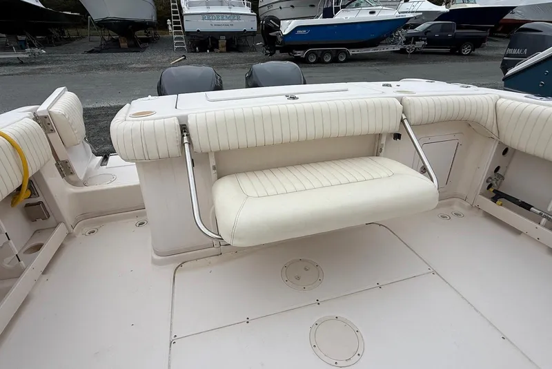 Slide: The Image of 2005 Grady-White Marlin 300 boat interior with foldable seating and twin engines. - 11