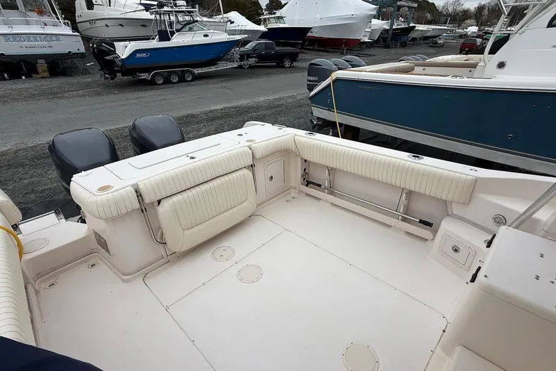 Slide: The Image of 2005 Grady-White Marlin 300 boat deck with twin outboard motors in a marina. - 12