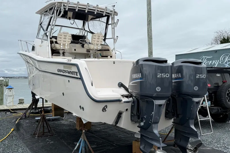 Slide: The Image of 2005 Grady-White Marlin 300 boat with twin Yamaha 250 engines on a dock. - 13