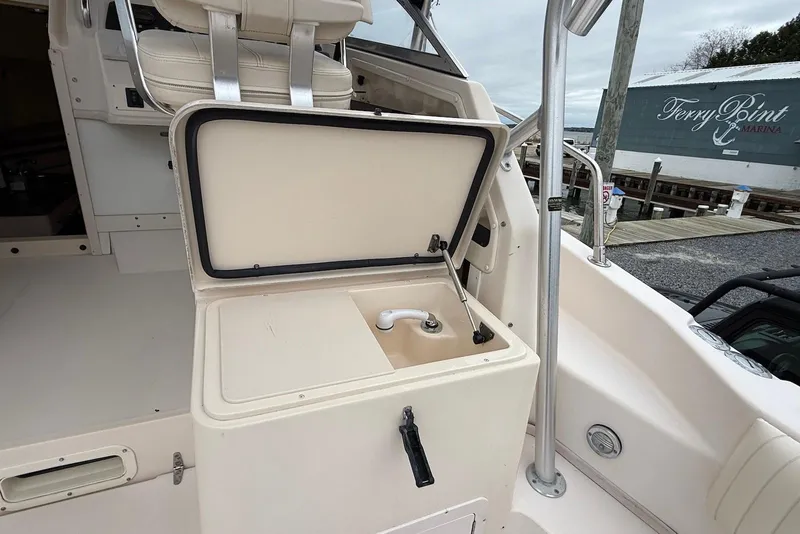 Slide: The Image of 2005 Grady-White Marlin 300 boat interior with open storage compartment at marina. - 16