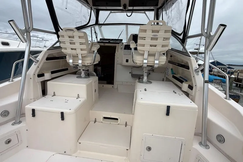 Slide: The Image of 2005 Grady-White Marlin 300 boat interior with helm seats and storage compartments. - 17