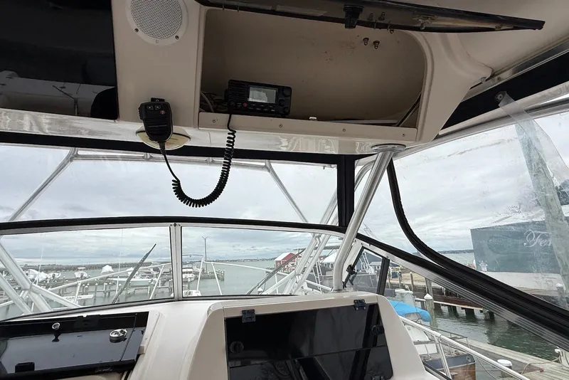 Slide: The Image of 2005 Grady-White Marlin 300 boat cockpit with radio and marina view. - 18