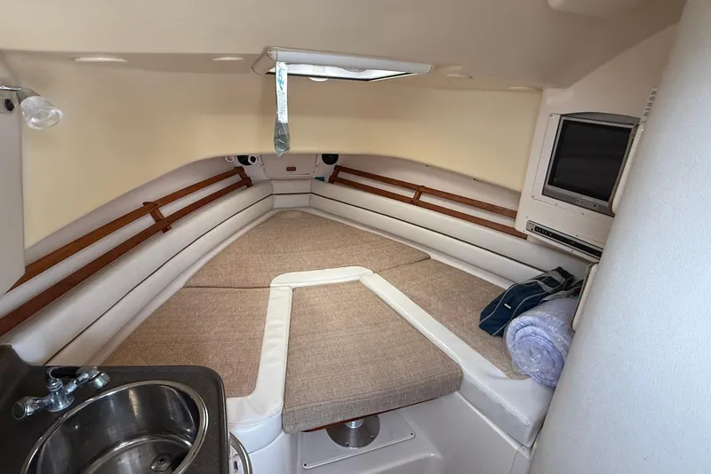 Slide: The Image of 2005 Grady-White Marlin 300 cabin interior with bed, sink, and TV. - 19