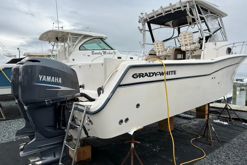 Slide: The Image of 2005 Grady-White Marlin 300 boat with Yamaha outboard motor on a dock. - 2