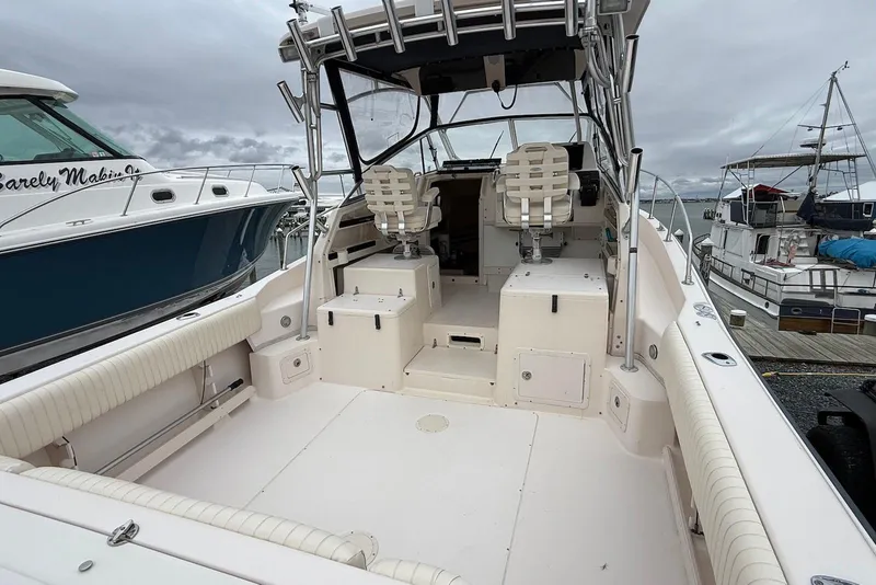 Slide: The Image of 2005 Grady-White Marlin 300 boat interior with seating and helm, docked at marina. - 22
