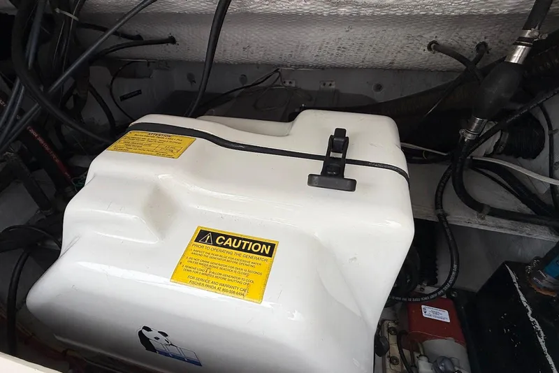 Slide: The Image of Engine compartment of a 2005 Grady-White Marlin 300 boat with caution labels. - 24