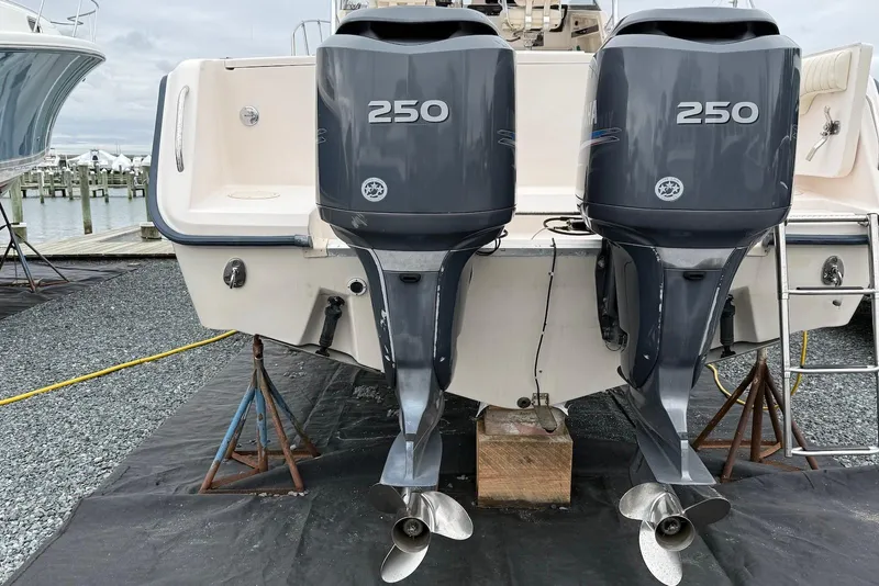 Slide: The Image of 2005 Grady-White Marlin 300 with twin 250 horsepower outboard engines at a marina. - 26