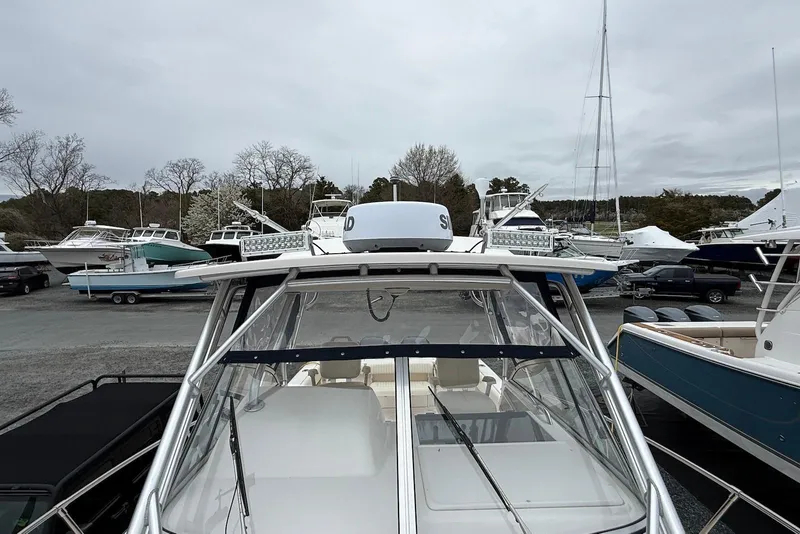 Slide: The Image of 2005 Grady-White Marlin 300 boat docked among other vessels on a cloudy day. - 3