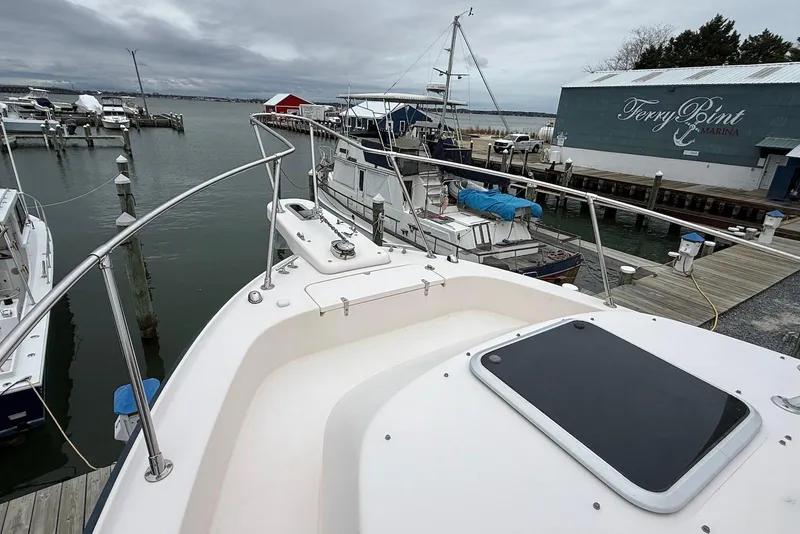 Slide: The Image of 2005 Grady-White Marlin 300 docked at Ferry Point Marina, overcast sky. - 4