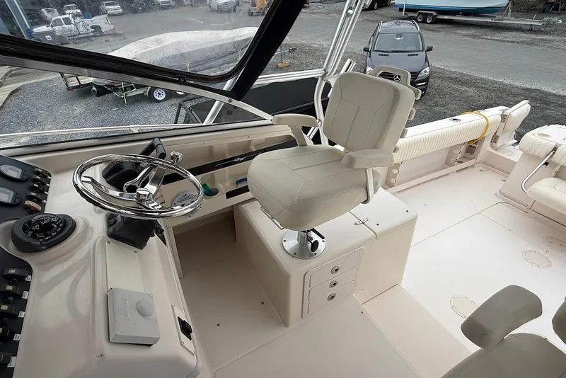 Slide: The Image of 2005 Grady-White Marlin 300 boat cockpit with steering wheel and captain's chair. - 5