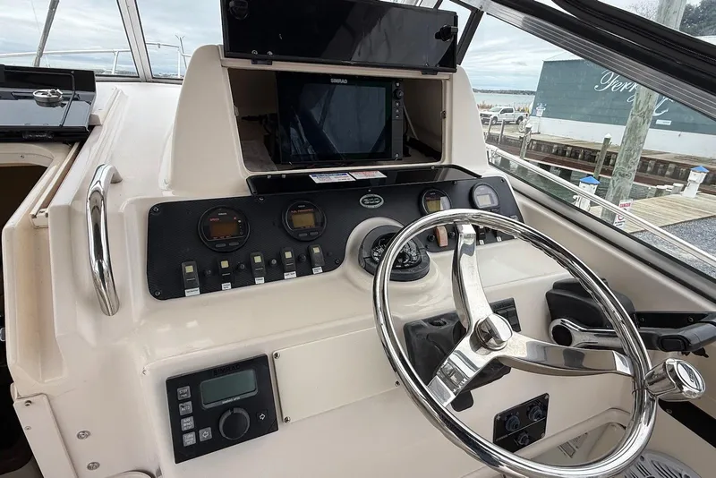 Slide: The Image of Helm of 2005 Grady-White Marlin 300 boat with steering wheel and navigation instruments. - 6