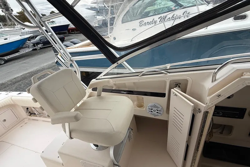 Slide: The Image of 2005 Grady-White Marlin 300 boat interior with helm seat and open storage compartment. - 7