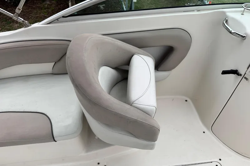 Slide: The Image of 2003 Sea Ray 240 Sundeck interior with white and gray seating. - 11