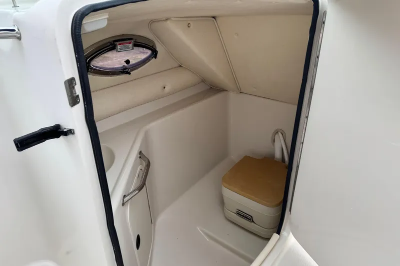 Slide: The Image of Interior of 2003 Sea Ray 240 Sundeck boat with compact marine toilet. - 15