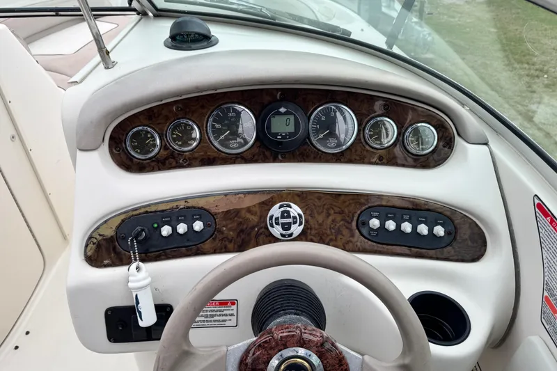 Slide: The Image of Dashboard of a 2003 Sea Ray 240 Sundeck boat with gauges and controls. - 17