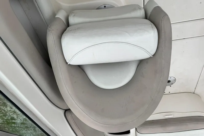 Slide: The Image of Boat seat on a 2003 Sea Ray 240 Sundeck, featuring white and beige upholstery. - 18