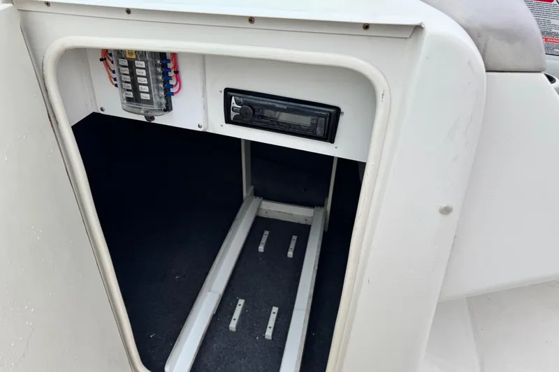 Slide: The Image of Interior view of a 2003 Sea Ray 240 Sundeck boat showing electrical panel and stereo system. - 20