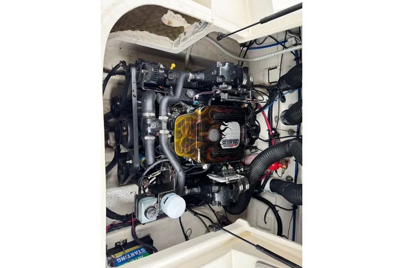 Slide: The Image of Engine compartment of a 2003 Sea Ray 240 Sundeck boat, showcasing detailed components. - 22