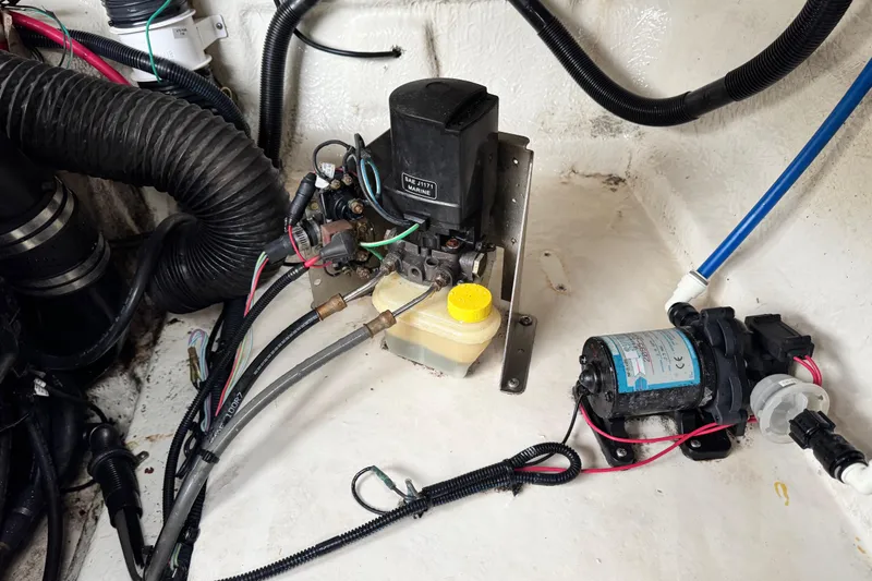 Slide: The Image of Engine compartment of a 2003 Sea Ray 240 Sundeck with visible wiring and components. - 25