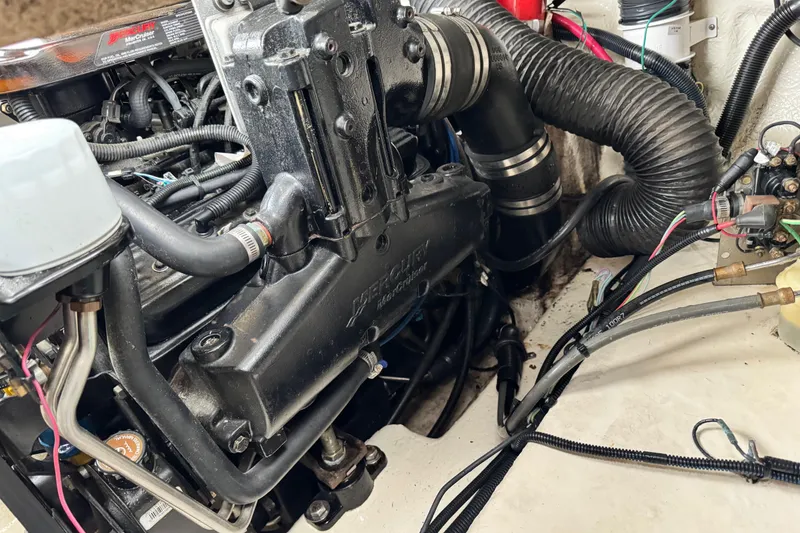 Slide: The Image of Engine compartment of a 2003 Sea Ray 240 Sundeck boat, featuring a MerCruiser engine. - 26