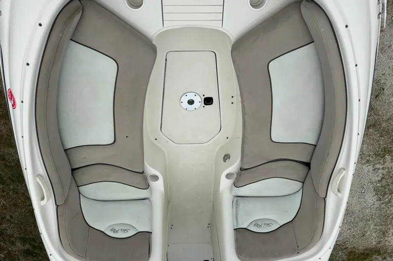Slide: The Image of 2003 Sea Ray 240 Sundeck boat interior with beige and white seating. - 28