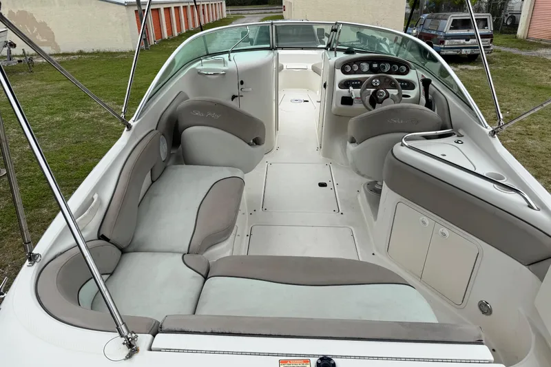 Slide: The Image of 2003 Sea Ray 240 Sundeck interior with spacious seating and modern dashboard. - 6