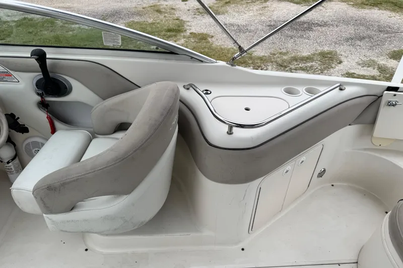 Slide: The Image of Interior of a 2003 Sea Ray 240 Sundeck boat with seating and control panel. - 9