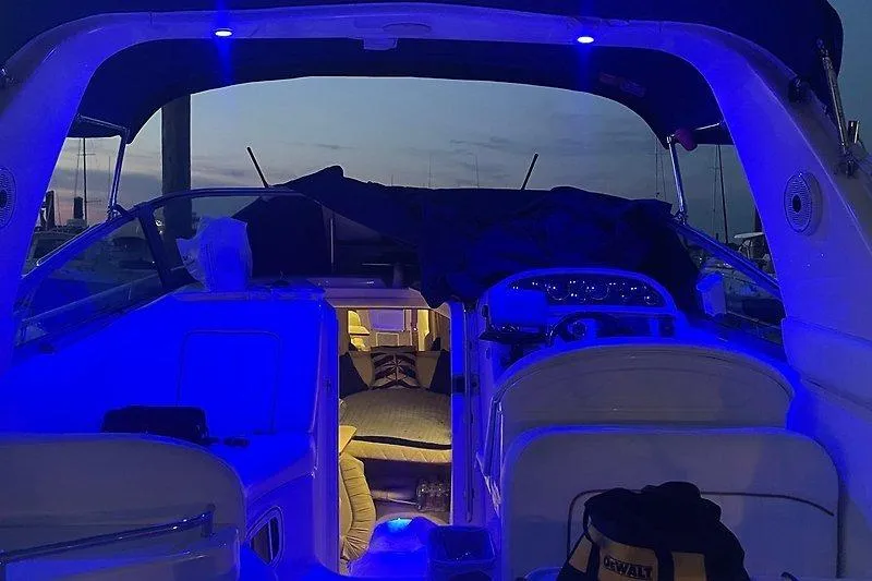 Slide: The Image of 2001 Sea Ray 290 Sundancer interior with blue ambient lighting at dusk. - 10