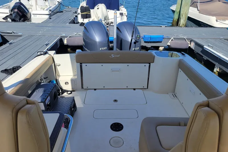 Slide: The Image of 2020 Scout 255 Dorado boat interior with twin 150 engines at dock. - 10