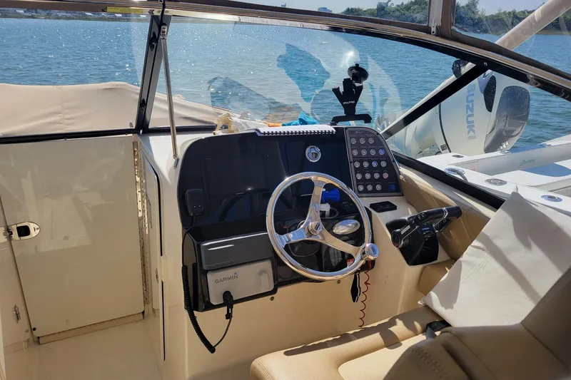 Slide: The Image of Helm of 2020 Scout 255 Dorado boat with Garmin navigation system and Suzuki engine. - 12