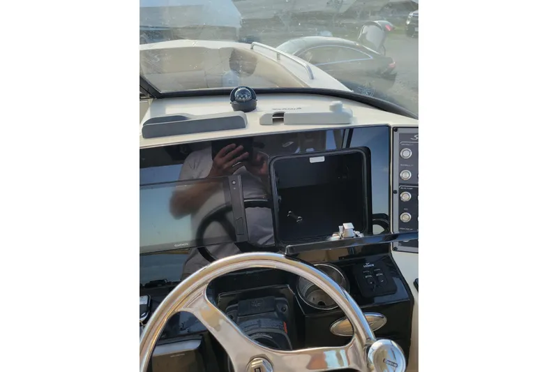 Slide: The Image of 2020 Scout 255 Dorado boat dashboard with steering wheel and control panel. - 14