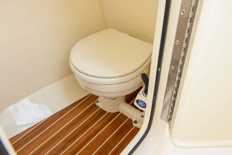 Slide: The Image of Manufacturer Provided Image: 2020 Scout 255 Dorado boat bathroom with toilet and wood flooring. - 17