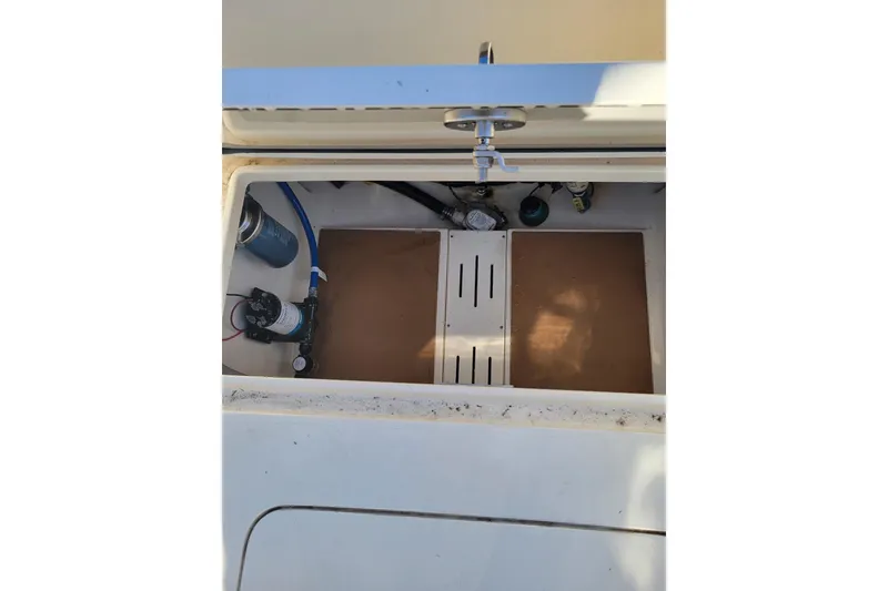 Slide: The Image of 2020 Scout 255 Dorado boat storage compartment with plumbing and equipment. - 20
