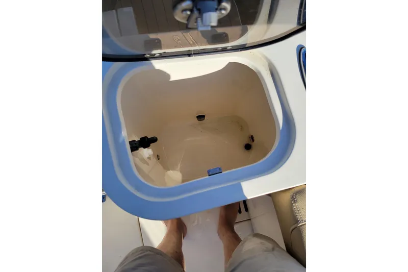 Slide: The Image of Open storage compartment on 2020 Scout 255 Dorado boat, viewed from above. - 21