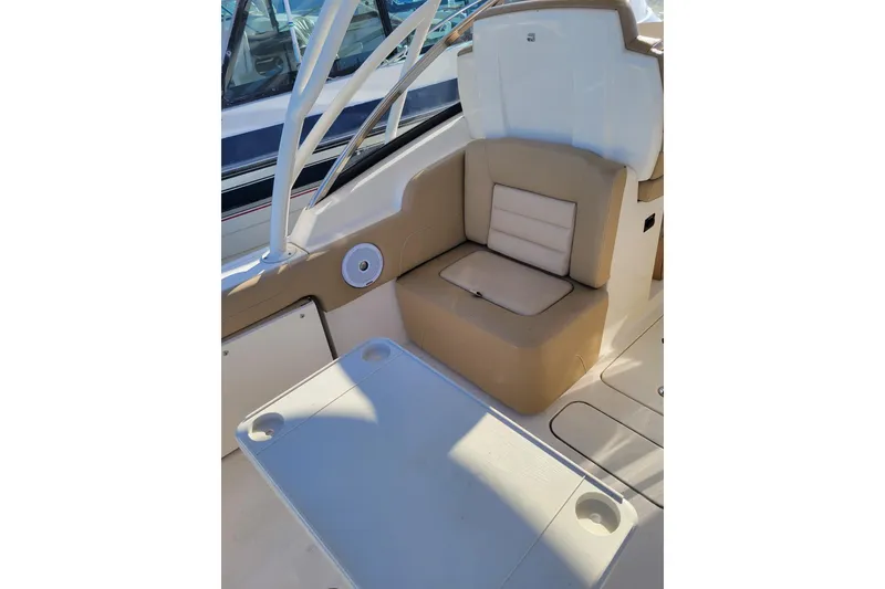 Slide: The Image of 2020 Scout 255 Dorado boat interior with beige seating and table. - 23