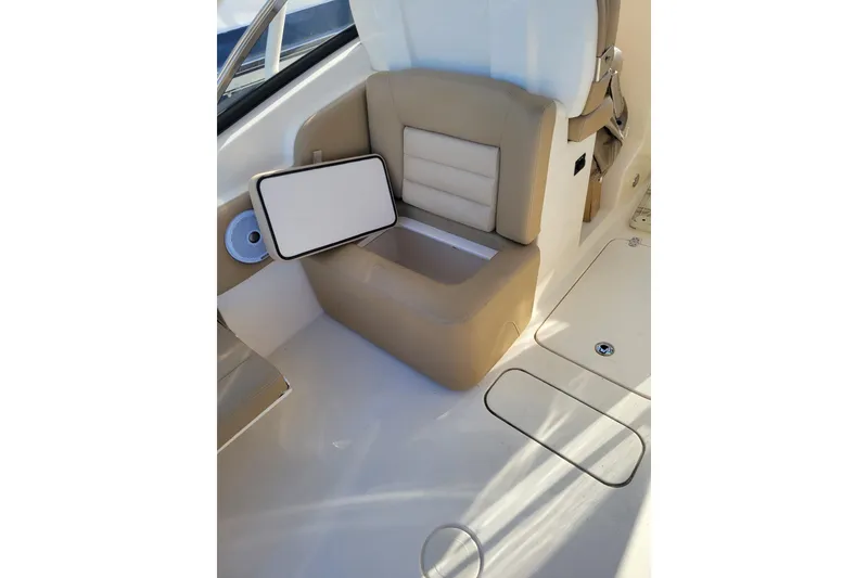 Slide: The Image of 2020 Scout 255 Dorado boat interior with tan seating and storage compartment. - 24