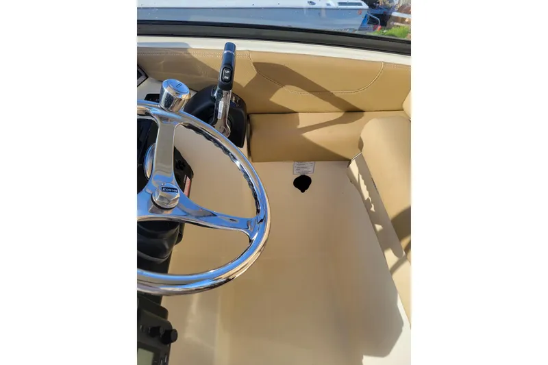 Slide: The Image of 2020 Scout 255 Dorado boat helm with steering wheel and throttle controls. - 29