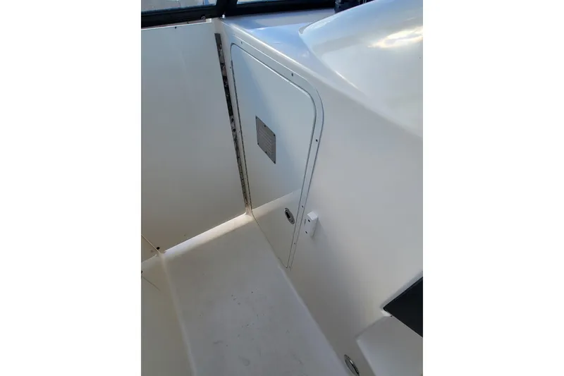 Slide: The Image of Interior view of a 2020 Scout 255 Dorado boat, featuring a white cabin door. - 30