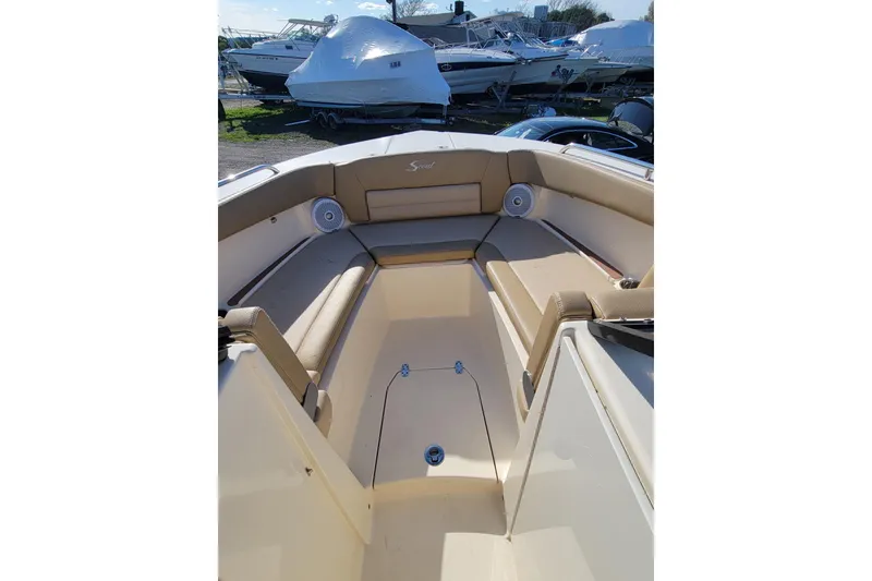 Slide: The Image of 2020 Scout 255 Dorado boat interior with beige seating and speakers. - 31