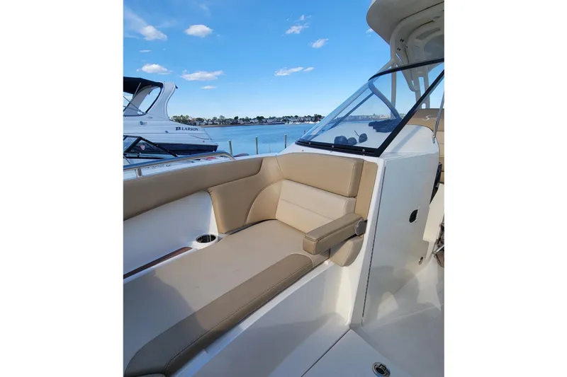 Slide: The Image of Scout 255 Dorado 2020 with beige seating area and blue sky. - 32