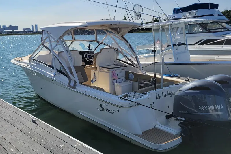 Slide: The Image of 2020 Scout 255 Dorado boat docked, featuring Yamaha engines, on a sunny waterfront. - 4