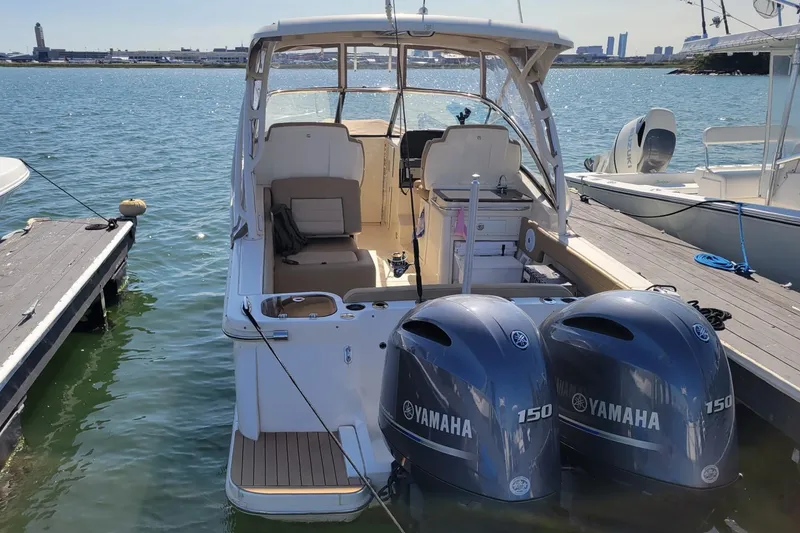 Slide: The Image of 2020 Scout 255 Dorado boat docked with twin Yamaha 150 engines. - 6