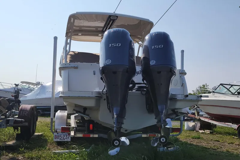 Slide: The Image of 2020 Scout 255 Dorado boat with dual Yamaha 150 engines, parked on a trailer. - 7