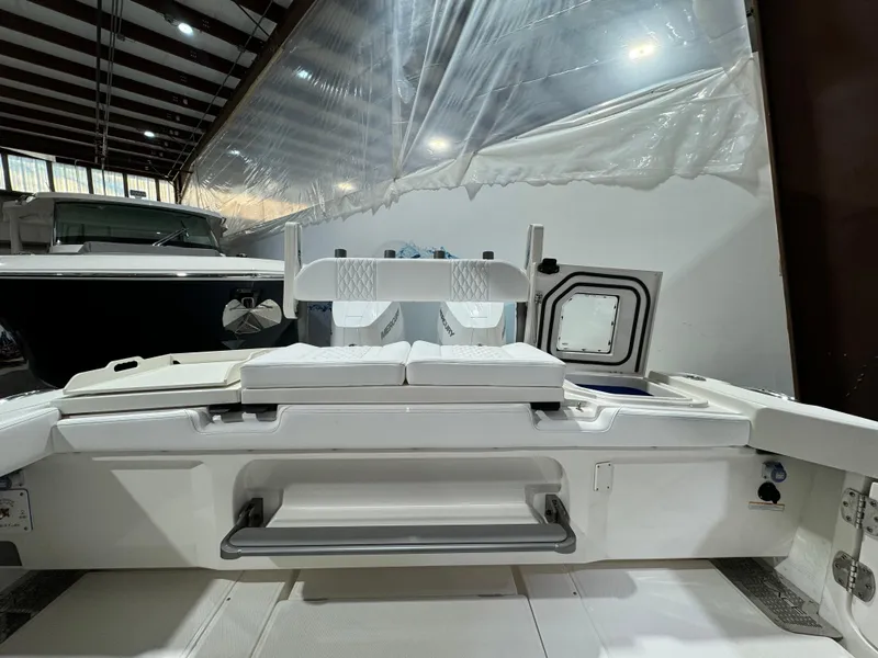 Slide: The Image of Luxurious white seating on 2025 Solace 32 CS boat, docked at marina. - 10