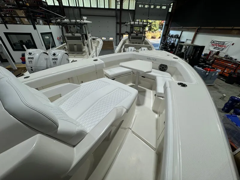 Slide: The Image of 2025 Solace 32 CS boat interior with wooden cabinetry, toilet, and sink. - 12