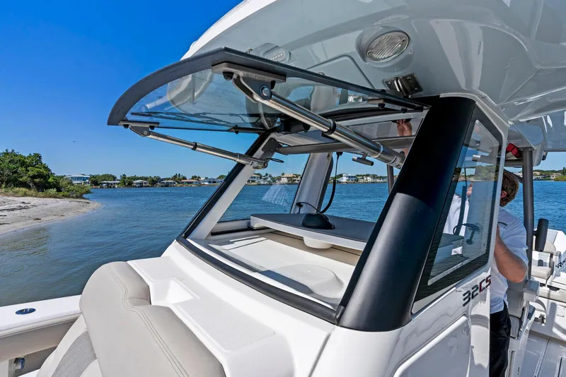 Slide: The Image of 2025 Solace 32 CS boat with dual outboard engines docked at marina. - 5