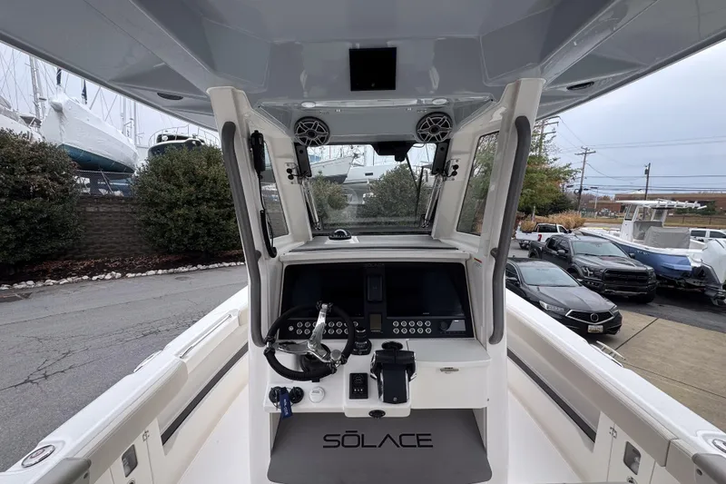 Slide: The Image of 2025 Solace 30 HCS boat cockpit with modern controls and steering wheel. - 11