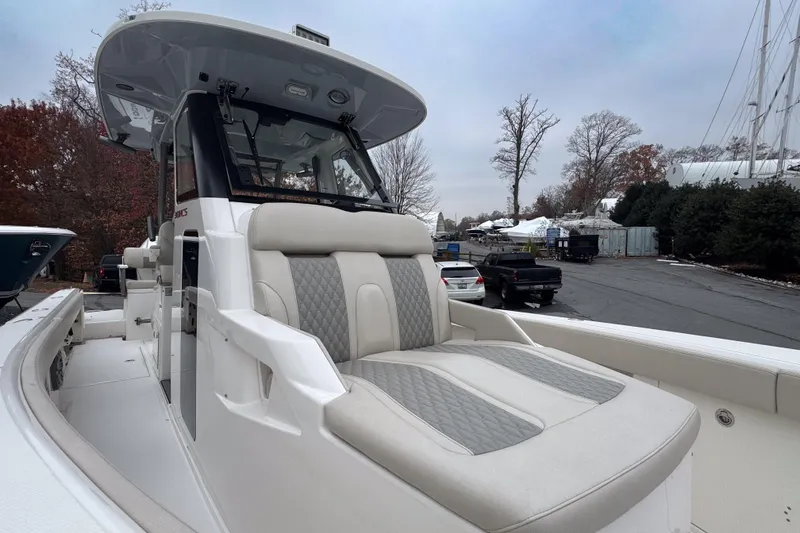 Slide: The Image of 2025 Solace 30 HCS boat with luxurious seating, docked outdoors. - 16