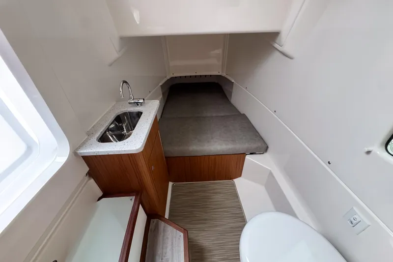 Slide: The Image of 2025 Solace 30 HCS cabin interior with sink, bed, and toilet. - 19