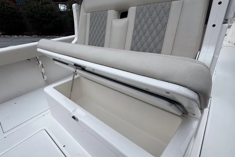 Slide: The Image of 2025 Solace 30 HCS boat seat with storage compartment open. - 7
